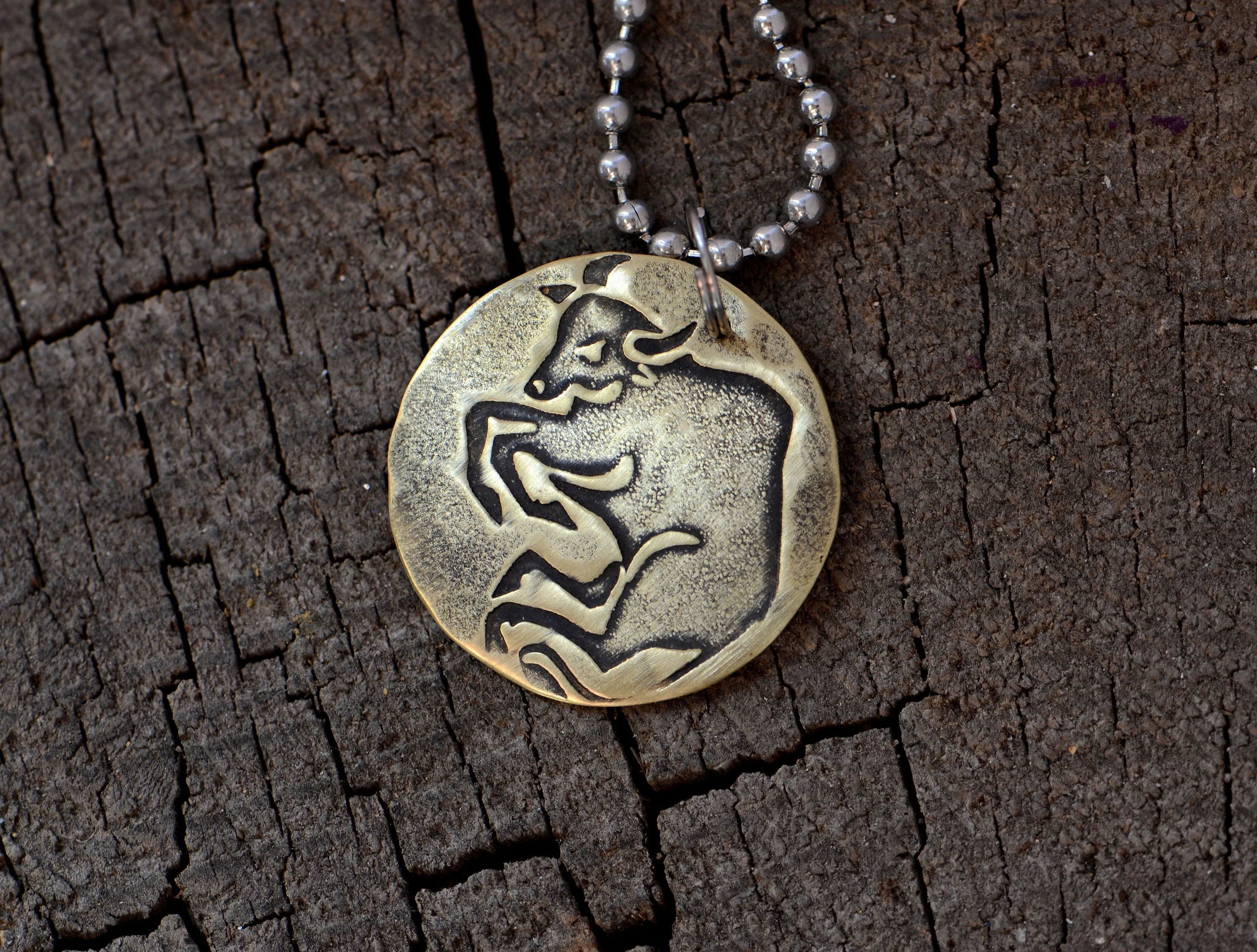 Taurus Zodiac on a brass disc necklace